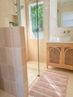 a bath room with a toilet a sink and a shower head mounted to the side of a wall