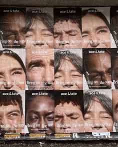 many pictures of men with different facial expressions on the side of a building in front of them