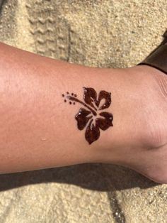 a person with a flower tattoo on their left arm and the other half of her leg