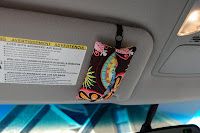 the interior of a vehicle with an advertisement on the back wall and seat belt hanging from the ceiling