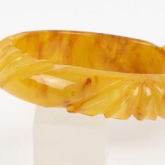 This is part of Chairish’s Costume Jewelry assortment.  This is a lovely yellow egg yolk and red wine marble Bakelite carved bracelet bangle. It features a spacer domed shape with deep geometric carving all around. The color is an intense yellow egg yolk tone with red wine and white cloudy swirling.  Measurements: Inside across is 2.57 in diameter (6.5 cm) - outside across is 3.19 in diameter (8 cm) - width is 0.63 in wide (1.5 cm) - The inner circumference of the bracelet is 8.03 in (20.41 cm). Elegant Bakelite Bracelet Jewelry, Elegant Bakelite Bracelet, Handmade Bakelite Bangle Bracelet, Handmade Round Bakelite Jewelry, Elegant Bakelite Bangle As Gift, Elegant Bakelite Bangle As A Gift, Handmade Bakelite Bracelets As Gift, Intaglio Bangle Bracelets As A Gift, Intaglio Bangle Bracelet As Gift