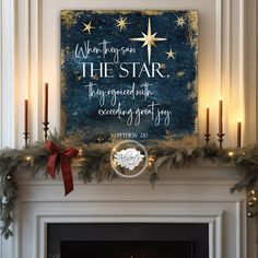 a christmas mantle with candles and a sign that says, when there is the star they created