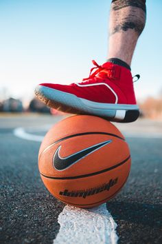 a person standing on top of a basketball