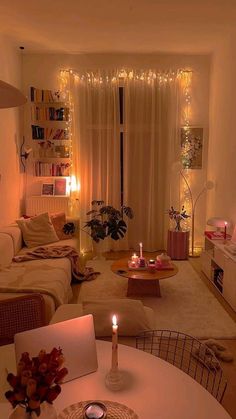 a living room filled with furniture and a lit candle in the middle of the room