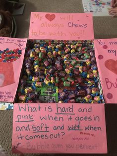 a box filled with lots of candy sitting on top of a floor next to other boxes