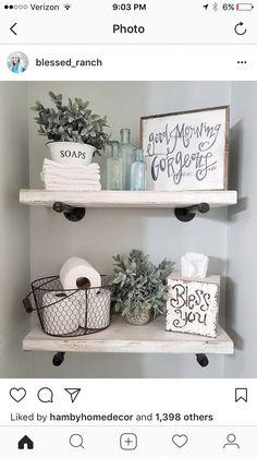 two shelves with toilet paper and other items on top of them, one shelf is white