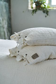 two white pillows are stacked on top of each other