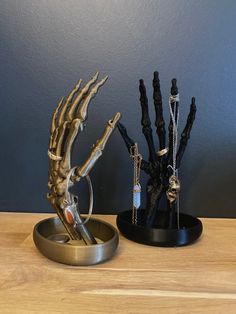 Add a touch of spooky elegance to your jewelry collection with our Skeleton Hand Jewelry Holder with Dish. Made from PLA 3D Printed, this unique piece features a skeleton hand with a dish style base perfect for holding your rings, earrings, and other small trinkets. Perfect for any gothic-inspired decor, this jewelry holder is a must-have for any jewelry lover.  Organize your jewelry in style with our eco-friendly PLA Skeleton Hand Jewelry Holder with Dishes. Made from sustainable and biodegradable PLA material. 📦 Shipping: UK, Europe 1-3 days. USA 4-9 days or 1-3 days with available Express Shipping Upgrade. COLOURS AVAILABLE:  Black, White, Yellow Gold, Dark Gold. DIMENSIONS:  Height: 20 cm MATERIAL: PLA Men Jewelry Holder, Skeleton Hand Jewelry, Hand Jewelry Holder, Jewelry Stand Display, Jewellery Organisation, Hands Jewelry, Jewelry Table Display, Jewlery Holder, Jewerly Organizer