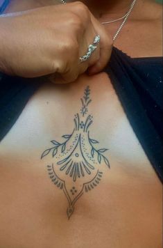 a woman's stomach with a tattoo on her chest and the bottom part of her body