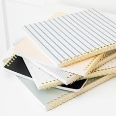 several notebooks stacked on top of each other