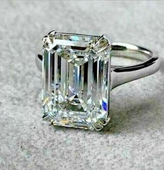 an emerald - cut diamond ring is shown on the ground, in this undrecognized image