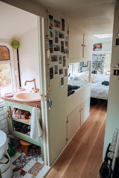 a bathroom with two beds and a sink