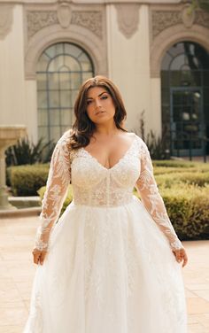 a woman in a wedding dress standing outside