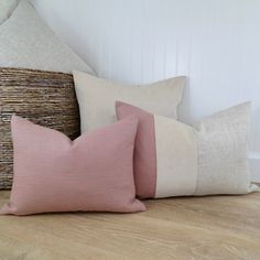 three pillows sitting on top of a wooden floor