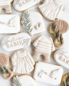 some cookies that are laying on top of each other and decorated with baby's names