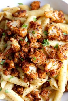 pasta with chicken and parmesan cheese in a white bowl