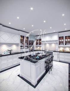 a large kitchen with white cabinets and black counter tops