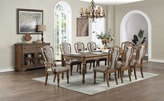 a dining room table with chairs and a chandelier