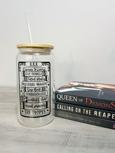 a glass jar sitting next to a stack of books