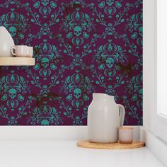 a purple wallpaper with skulls and flowers on it in a kitchen or dining room