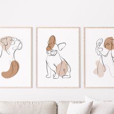 three framed art prints on the wall above a couch