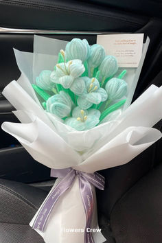 a bouquet of flowers sitting in the back seat of a car