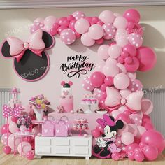 a minnie mouse birthday party with balloons and decorations