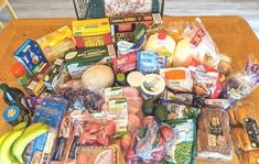 a wooden table topped with lots of different types of foods and condiments on top of it