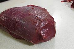 a piece of raw meat sitting on top of a counter