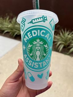 someone holding up a starbucks cup with a straw in it