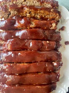 sliced meatloaf on a white plate with sauce