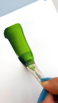 a person holding a toothbrush in their left hand