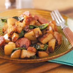 a close up of a plate of food with potatoes and spinach on the side