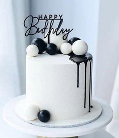 a birthday cake with black and white decorations