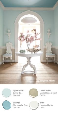 the color scheme for this dining room is light blue and has white furniture with pink flowers on