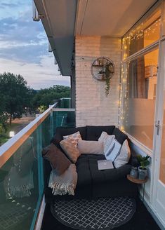 a black couch sitting on top of a balcony