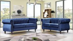 two blue velvet sofas in a living room