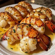 some shrimp is sitting on a white plate