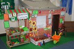 a doll house made to look like a child's play area with toys and decorations