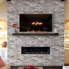 a living room filled with furniture and a flat screen tv mounted on the wall above a fire place