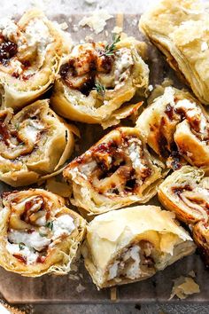 several rolls with meat and cheese are on a baking sheet, ready to be eaten