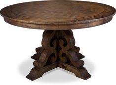 a round wooden table with an intricate design on the top and base, made out of wood