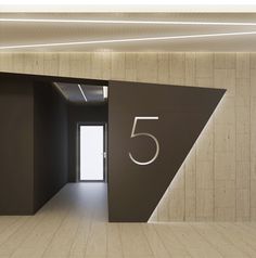 an open door leading into a room with the number five on it's side