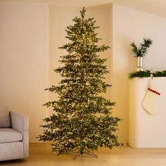 a small christmas tree in the corner of a room