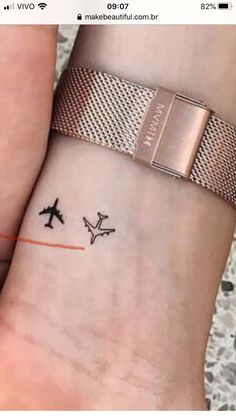 two people with matching tattoos on their wrist