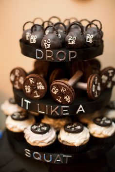 a three tiered cake with chocolate cupcakes on top that says drop it like a squat