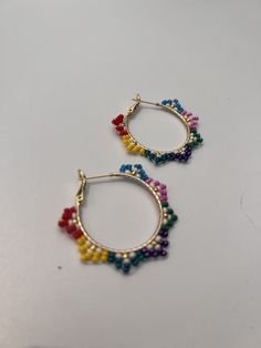 If you need a statement earring or even an accent earring, you have come to the right place.  These earrings add that fun to your day and your style.  They feature hand sewn glass beads in a pointed pattern. The hoop is 18K gold plated brass. please contact me to discuss custom color palette. There are so many options! Jewelry Care: ~To keep your earrings in the best condition please store them either laying flat or hanging up. ~Avoid wearing these while exercising or swimming.  Excess moisture can effect the coloring and condition of the beads and ear wires. ~The beads are glass so they can break when dropped or crushed on a hard surface. Please Note: ~Lighting can affect the color and brightness of the images. There may be some slight differences in the color tone/shade of the online pho Handmade Adjustable Fun Beaded Earrings, Trendy Hoop Beaded Earrings For Pierced Ears, Colorful Beaded Hoop Earrings For Party, Trendy Nickel-free Beaded Hoop Earrings, Nickel Free Small Hoop Beaded Earrings In Trendy Style, Small Hoop Beaded Earrings For Party, Trendy Hoop Beaded Earrings With Colorful Beads, Handmade Colorful Hoop Earrings, Trendy Round Beaded Earrings With Ear Wire