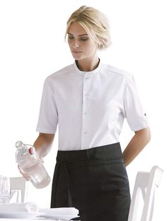 Whether you’re on the hunt for the perfect chef’s shirt or the ideal service shirt, this Unisex Chef/Service Shirt from Kentaur fits the bill with its modern styling and functional design. This professional button-down shirt offers everything you need in chef wear, including: 65/35 recycled poly cotton blend for durability and superior machine wash-ability High-quality, sewed on button closure with heavy-duty, contrasting thread Stand-up collar with a collar strap to keep your bib apron in place Modern Fitted Short Sleeve Work Shirt, Sleek Workwear Shirt With Button Cuffs, White Dress Shirt With Fold-down Collar For Work, Chef Shirt Design, Chef Shirt, Professional Aprons Chefs, Traditional Aprons, Chef Wear, Chef Coat