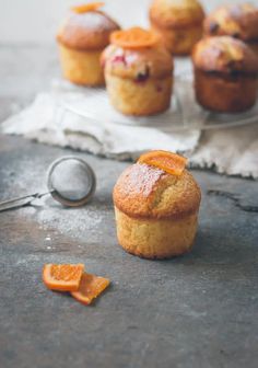 some muffins with orange slices on the side