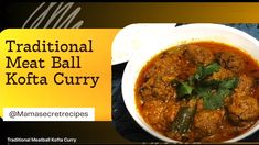 a bowl of meatball kofta curry with a fork and knife next to it